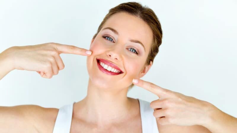 maintaining top oral health woman smile with hands