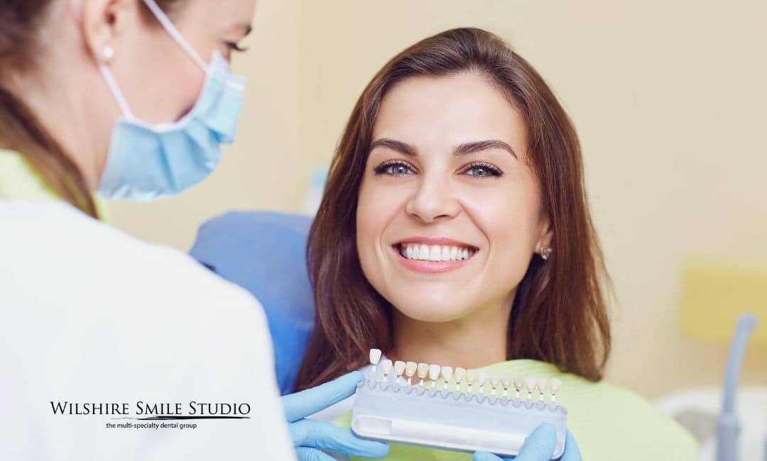 young woman checking teeth colors